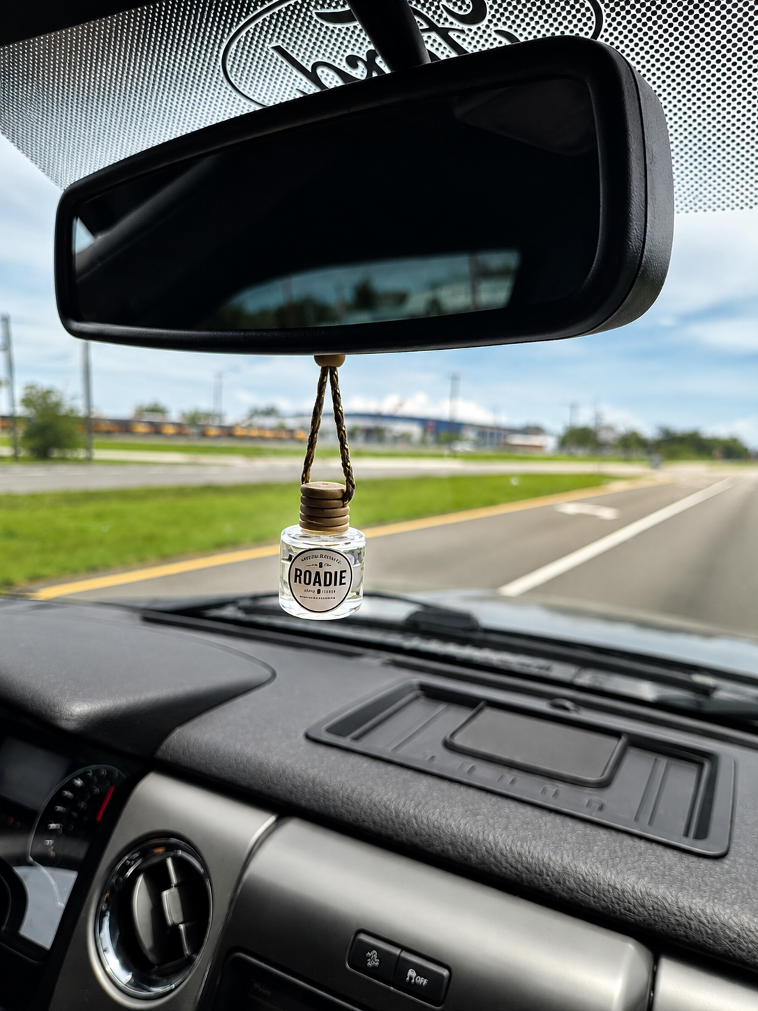 Second Pour Co. Roadie car diffuser hanging from a rearview mirror